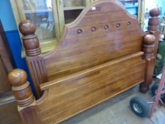 A mahogany bed frame, comprising a headboard and a foot board both having bulbous supports to each