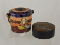 A Japanese biscuit barrel depicting a nobleman and woman, together with lacquer trinket box (2).