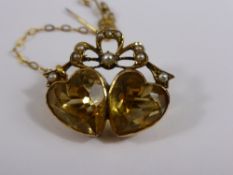 Edwardian Gold Citrine and Seed Pearl Brooch, the brooch in the form of two hearts with a ribbon