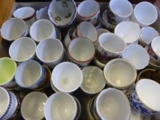 A large collection of porcelain egg cups, assorted shapes and decoration, approx. fifty five items.