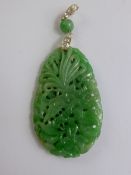 A Chinese 18 ct and silver Jadeite and Diamond Drop Pendant, the pendant finely carved with