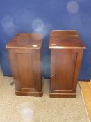 A pair of mahogany bedside cabinets.