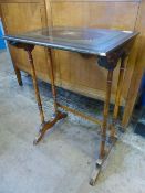 A Victorian Occasional table on turned spindle supports, the top having floral decoration to the