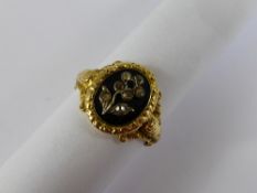 A Georgian Gold and Black Enamel Mourning Ring, the seal form ring having a central motif in the