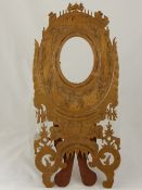 A Hand Carved Decorative Oval Frame, carved with birds and flowers.