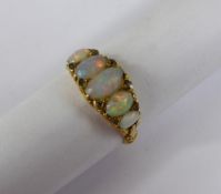 A Lady`s 18 ct Gold and Opal Diamond Ring, the gypsy style ring set with five graduated opals 7 at 4