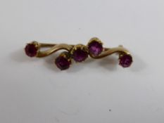 Victorian Gold and Ruby Brooch, the rubies are 5 x 4mm on a bow shaped bar, approx 4 gms
