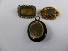 Three Georgian Mourning Brooches, including ornate gold floral, 9ct gold oval jet and pearl brooch