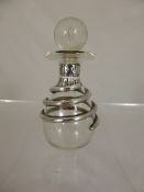 A cut glass and silver perfume bottle, unusual design.