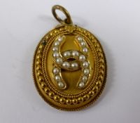 Edwardian 9ct Gilded Seed Pearl Mourning Locket, the oval shaped locket having beaded and roped edge