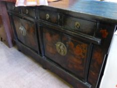 A large antique ebonised Chinoiserie sideboard fitted with four drawers and two sets of cupboards