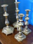 A Pair of Antique Brass Candlesticks, on beaded base together with two further brass candlesticks.