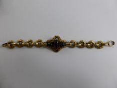 A Lady`s Edwardian 9 ct Gold and Garnet Bracelet, the bracelet set with three cabachon garnets in