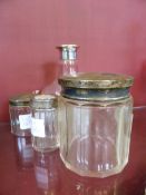 Three cut glass trinket jars with silver tops, two with Birmingham hallmark.