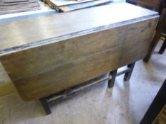 An antique oak drop leaf dining table fitted with a single drawer, approx. 108 x 118 x 71 cms.