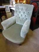 A Victorian Walnut Armchair by Howard & Sons, fully stamped, upholstered in green button back