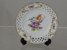 An antique hand painted miniature ribbon plate, the gilded plate depicting flowers.