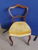 A pair of Victorian mahogany camel back bedroom chairs, the centre bars having entwined