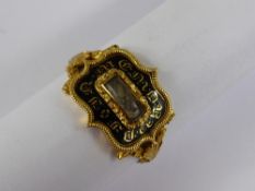 A Georgian Gold and Black Enamel Mourning Ring, the shaped seal form ring having laurel and floral