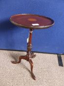 A Sheraton style mahogany wine table having inlaid cartouche to the top.