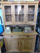 A Continental Pine Dresser, the top being glazed, the centre having a bowed element, the base having