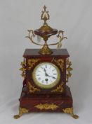 A Terracotta Marble and Gilt Brass Mantle Clock, white enamel face with Roman dial, decorative urn