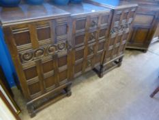 An oak break front and break top sideboard having four graduated drawers to the centre and a