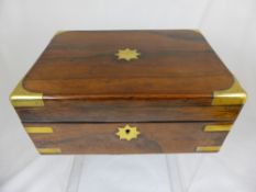 An antique rosewood sewing box having brass corners, est. 31 x 22 x 13 cms. when closed.