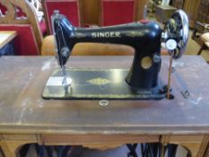 A vintage Singer sewing machine on a Jones treadle base.