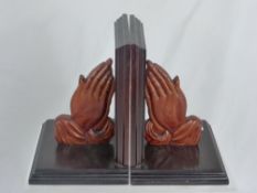 Two Wood Carved Book Ends, the first pair depicting hands clasped in prayer and the second pair