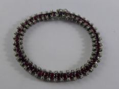 A Lady`s 18 ct White Gold, Ruby and Diamond Bracelet, the fine bracelet set with 43 rubies 3.2 mm