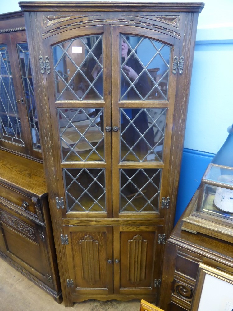 An Old Charm style oak corner cabinet, astral glazing to the top, cupboards under, est. 67 x 36 x