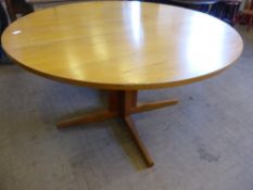 A Gordon Russell oval teak dining table being hand made by cabinet maker Leslie Bruce 1925 - 2000,