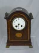 A French Mahogany Mantel Clock, enamel dial, the case with decorative inlay