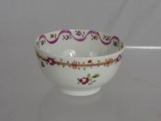 An Antique Newhall Tea Bowl, the hand painted tea bowl depicting flowers.