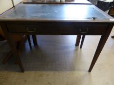 An Edwardian mahogany writing table having a black leather top and two drawers on tapered legs,