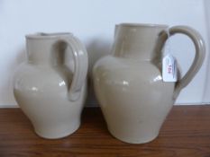 Two antique pottery jugs, one being est, 26 cms. in height, the other 24 cms. (2)