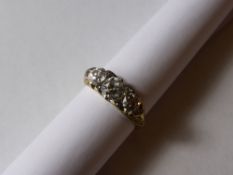 A Lady`s 18 ct Yellow Gold Three Stone Diamond Carved Head Ring, the ring set with old cut