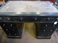 An Edwardian ebonised twin pedestal desk being leather topped, four drawers to each side and a