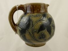 A Martin Bros Southam Jug dated 5/10/1891, the green glazed jug with ivy and clematis decoration,