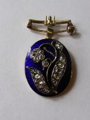 A Lady`s 18 ct Enamel and Diamond Brooch/Pendant, the oval brooch depicting flowers approx 95 pts