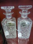 A Pair of Heavy Cut Glass Decanters, with two solid silver labels Whisky and Brandy.