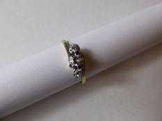 A Lady`s 18 ct Gold and Platinum 3-stone Diamond Crossover Ring, Centre dia 3.4 mm approx 15 pt, 2