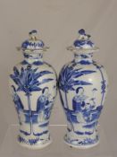 A Pair of Circa 19th Century Blue and White Baluster Lidded Vases, the vases depicting various