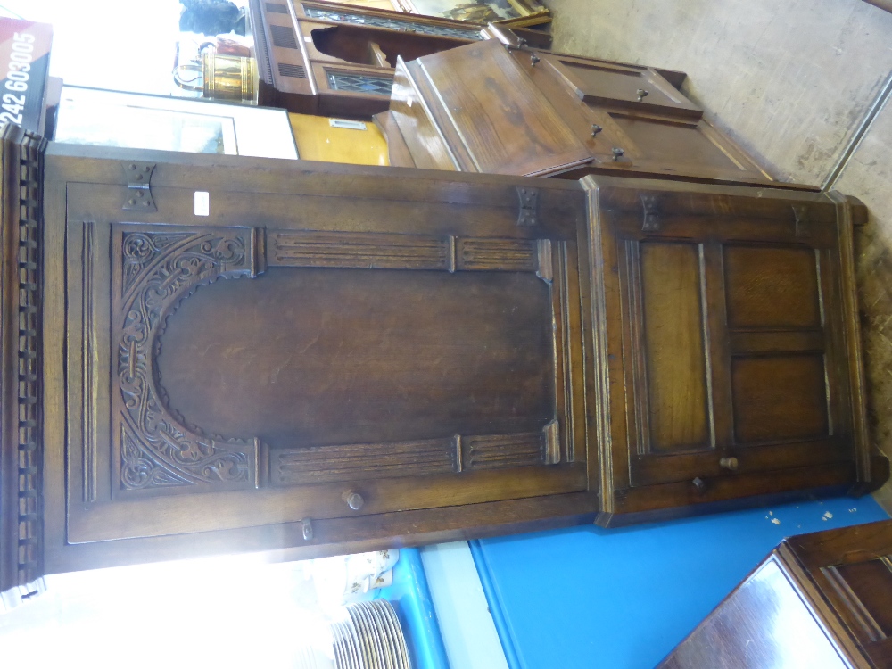 An Antique Oak Corner Cabinet, with double cupboard with decorative carving to door panels and