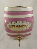 A Vintage Porcelain Brandy Barrel, with brass tap nr 1808 together with vintage brass and white