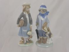 Two Lladro Figurines of a School Girl and a Boy, with a miscellaneous group of porcelain figures,