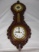 A Decorative Oak Cased Wall Barometer with clock.