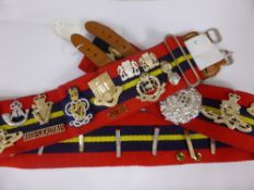 A modern day military trophy belt with thirty anodised badges including o.t.c. armoured  units,