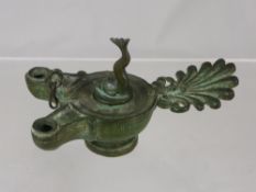 An Antique (possibly Roman) Bronze Oil Lamp, the lamp having a fantail handle with double width